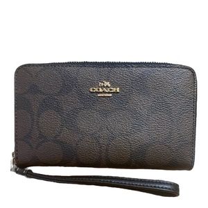 Coach monogram zippered wristlet wallet.